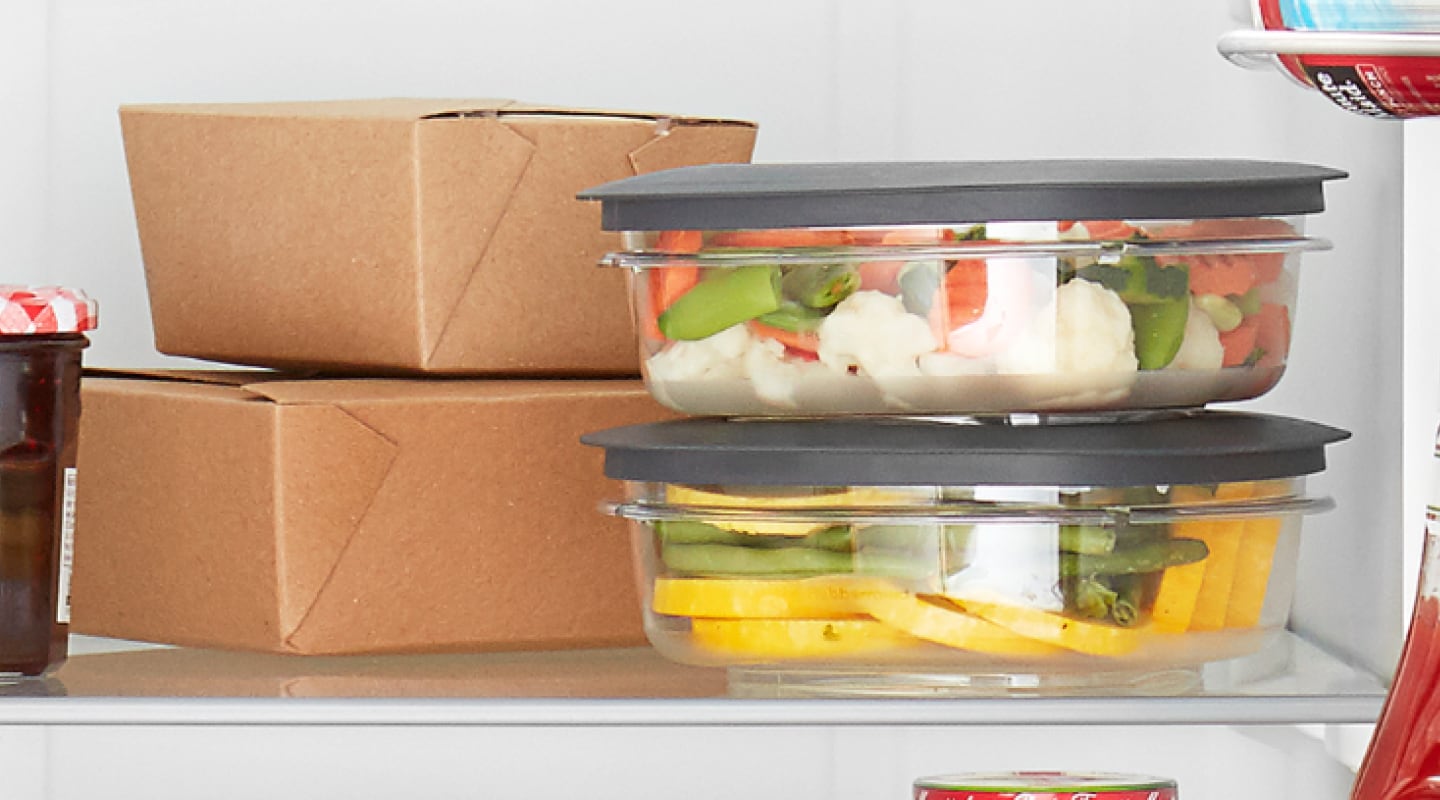 Take out and plastic containers on a refrigerator shelf Take out and plastic containers on a refrigerator shelf
